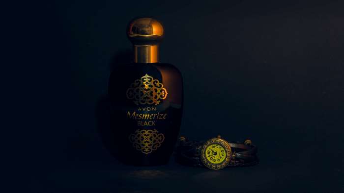 Avon Mesmerize Black perfume bottle and watch