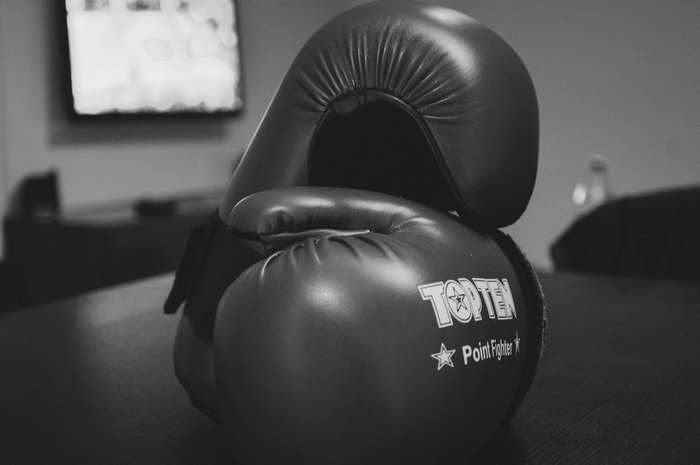 Black and white close-up of Top Ten Point Fighter boxing gloves