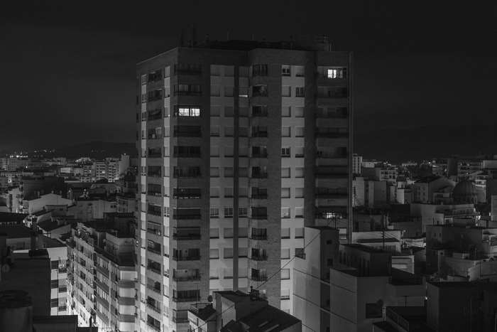 City skyline at night with illuminated apartment buildings