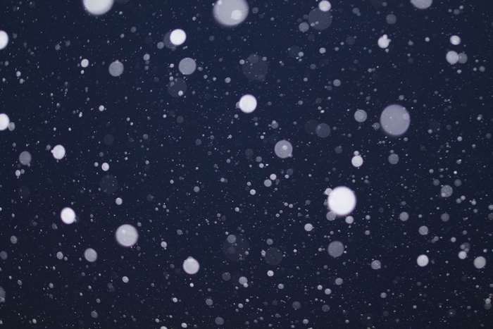 White snow bokeh on dark blue background