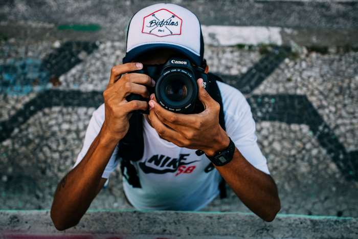 Photographer with Canon camera wearing Nike SB