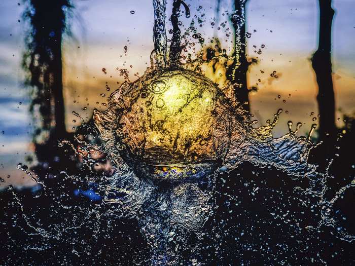 Sunset Reflected Through Splashing Water Droplet