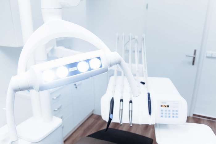 Dental clinic equipment with examination light and chair