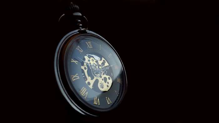 Close-up of a vintage pocket watch with Roman numerals