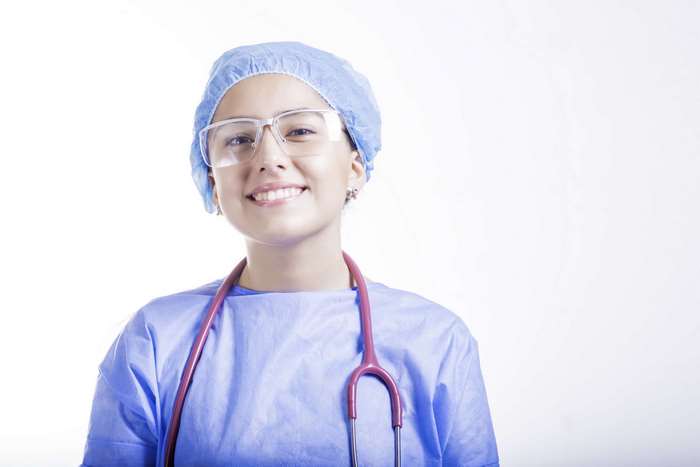 Doctor wearing surgical cap and gown with stethoscope