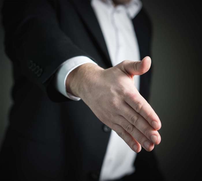 Man in Suit Offering Handshake