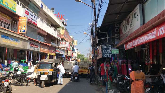 Street scene in India with shops and vehicles