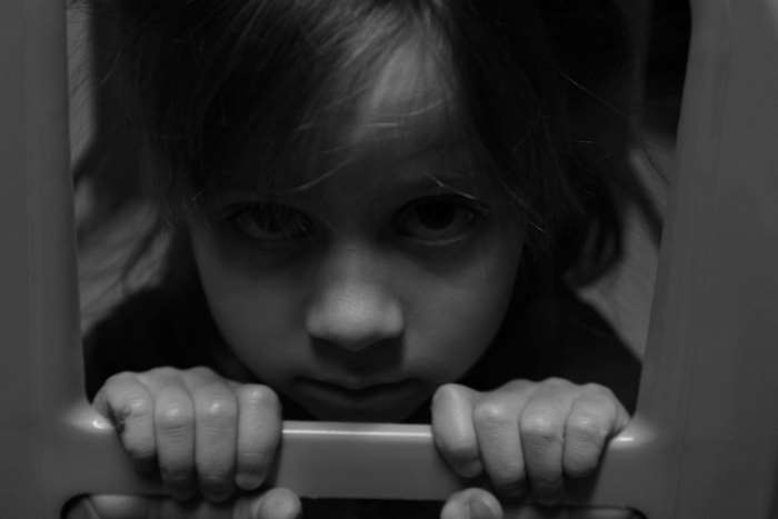 Black and white portrait of a sad young girl