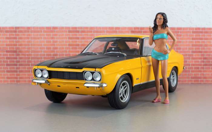 Yellow Ford Capri with a woman in a bikini