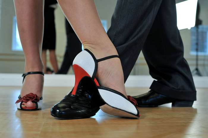 Couple dancing Argentine Tango in a studio