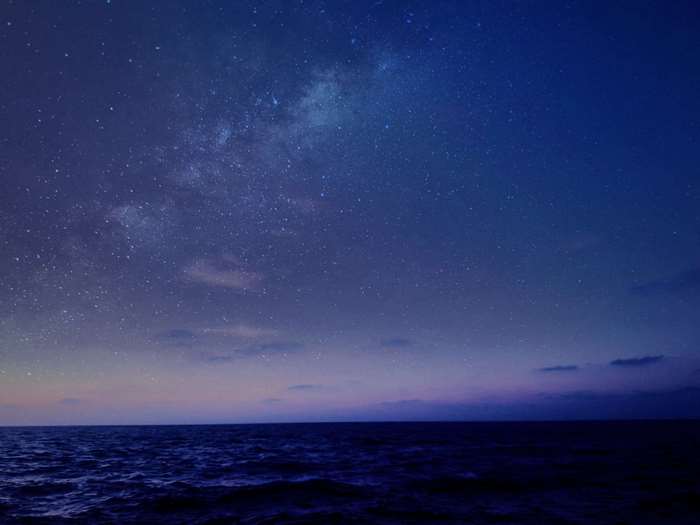Ocean under a starry night sky