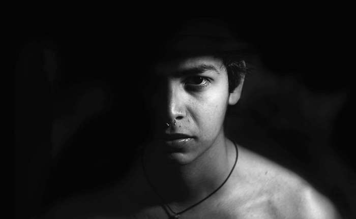 Man with nose ring in dark lighting 4K