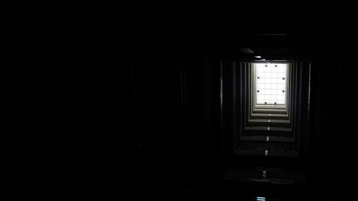 Dark building interior looking up at a skylight