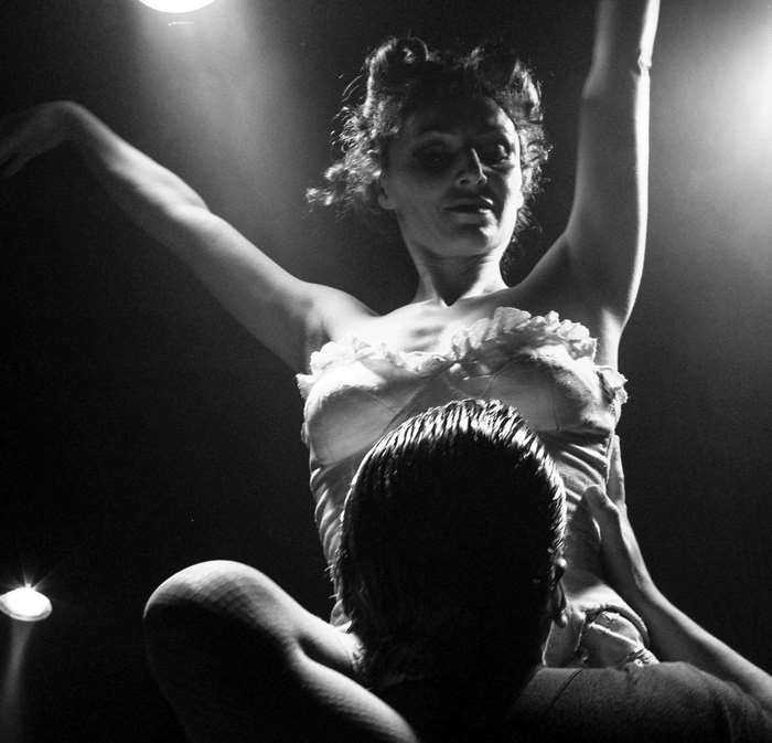 Woman performing ballet with a man lifting her