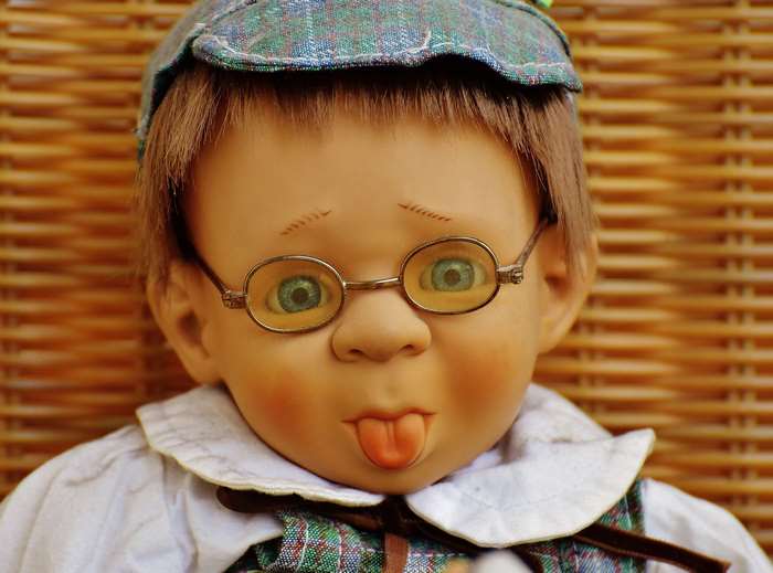 Doll with glasses sticking out tongue