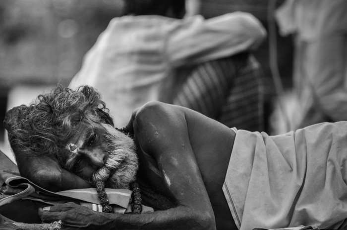 Old man with beard and traditional markings sleeping