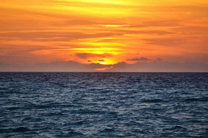 Sunset over the ocean with orange sky