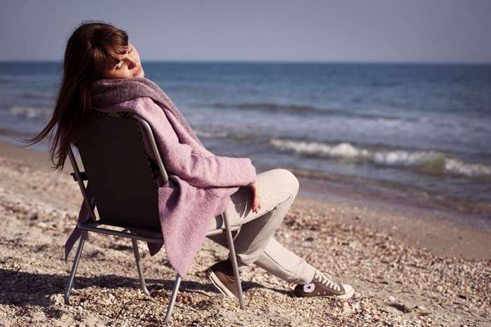 Woman relaxing on a beach by the ocean