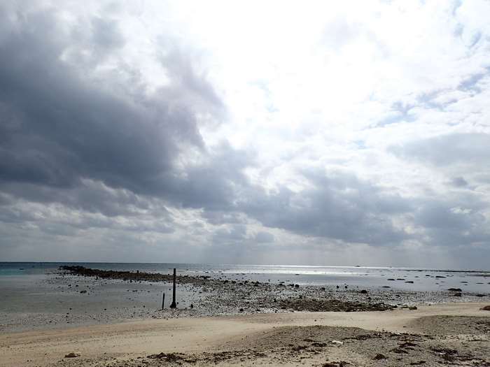 Cloudy sky over a rocky beach and the sea