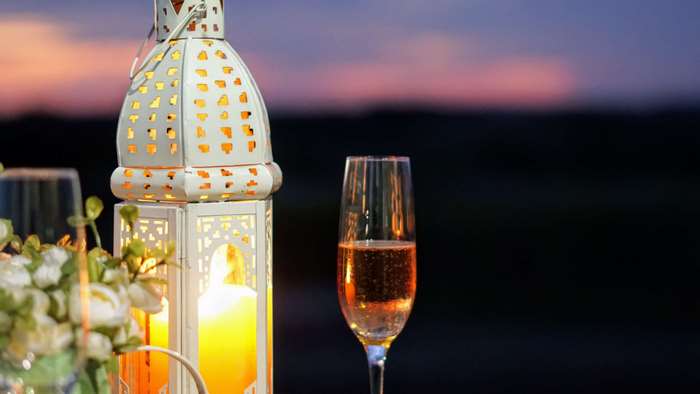 Champagne glass and lantern at sunset