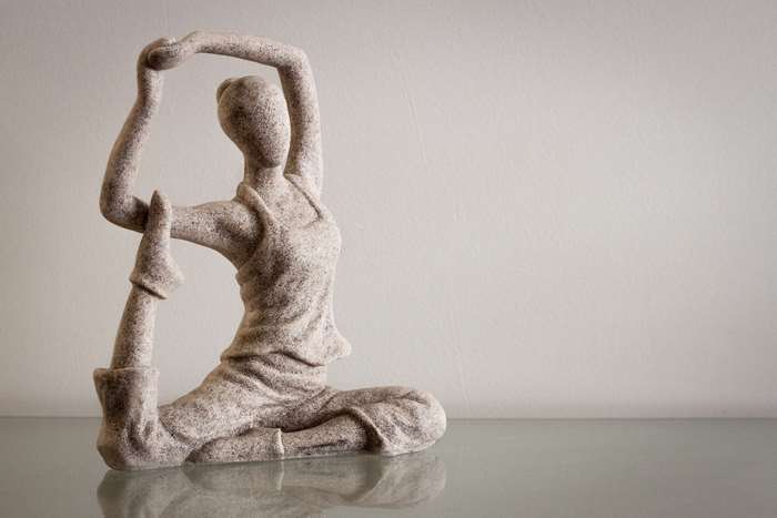Stone yoga figurine in a graceful pose