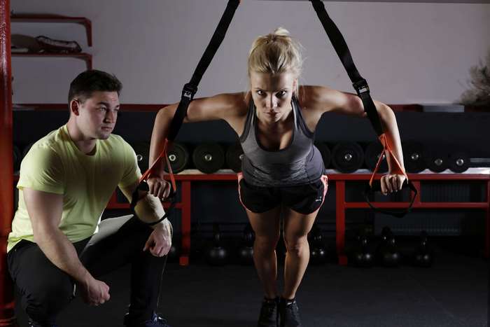 Focused Female Athlete Training with Suspension Straps