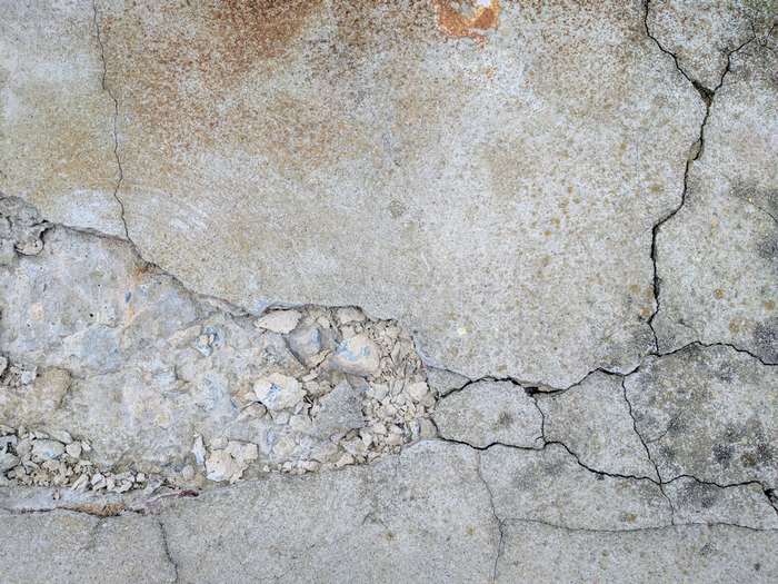 Cracked concrete texture with rust stains