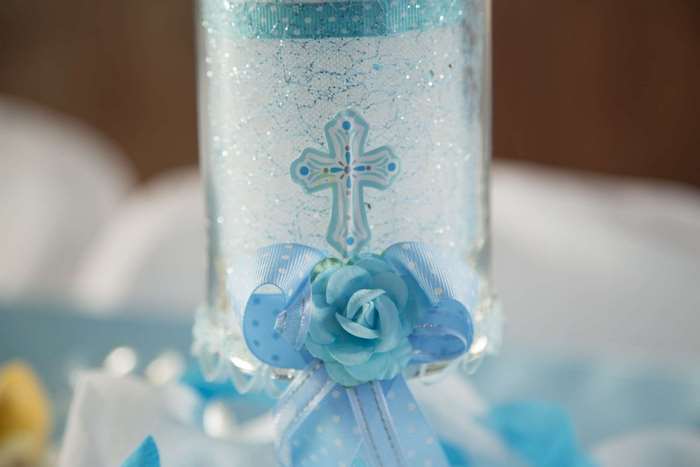 Decorated baptism candle with cross and blue rose