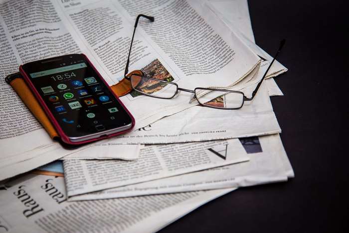Smartphone and Glasses on Newspapers