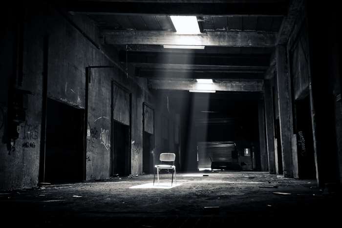 Abandoned building with chair and sunlight