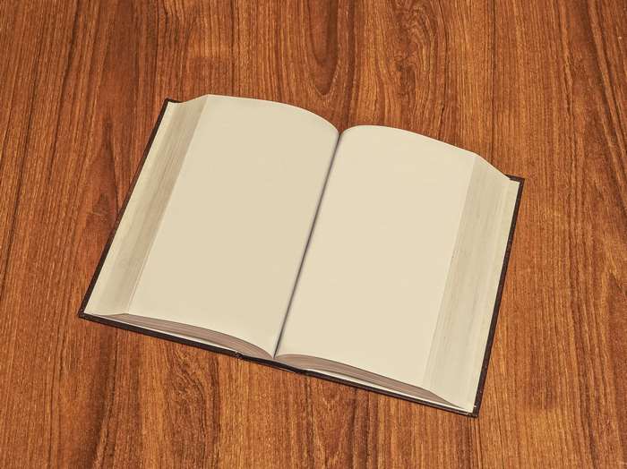 Blank open book on a wooden table