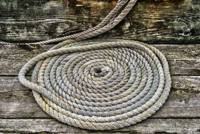 Coiled Rope on Weathered Wooden Planks 4K