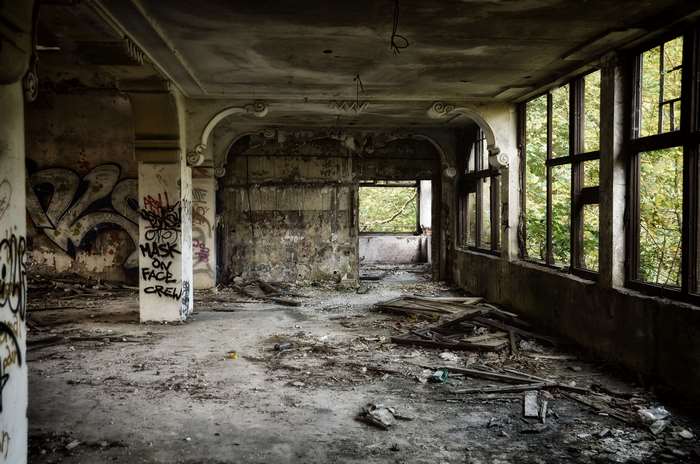 Abandoned room with graffiti and broken furniture