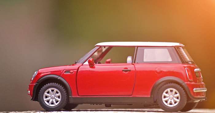 Red Mini Cooper toy car, side view, 4K