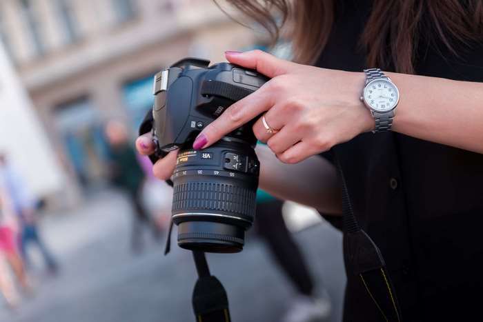 Woman with DSLR camera and watch