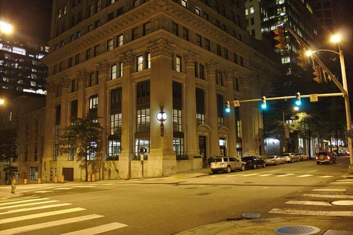City street at night with buildings and traffic lights