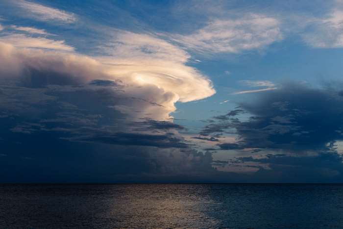 Dramatic Clouds Over Dark Ocean at Dusk