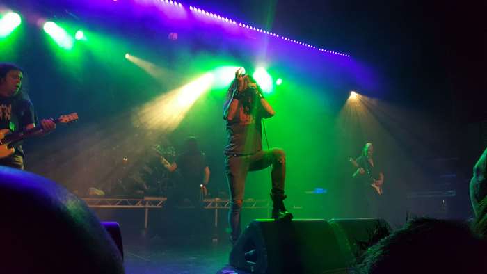 Band performing on stage with colorful lights