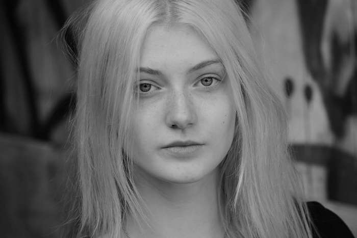 Black and white portrait of a young woman with blonde hair