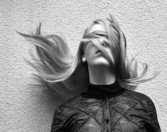 Woman with hair flying in black and white