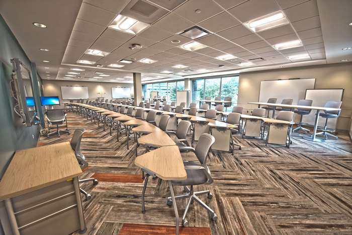 Modern empty classroom with desks and whiteboards