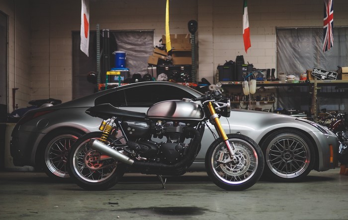 Motorcycle parked next to a car in a garage