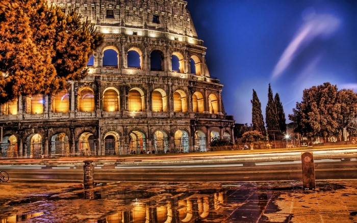 Colosseum at night with light trails in Rome, Italy