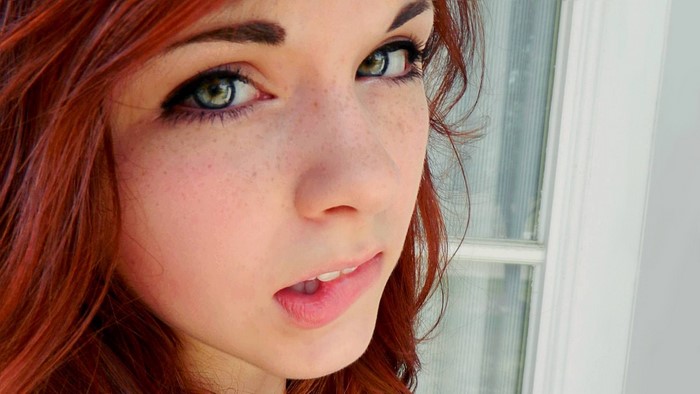Green-eyed girl with red hair and freckles