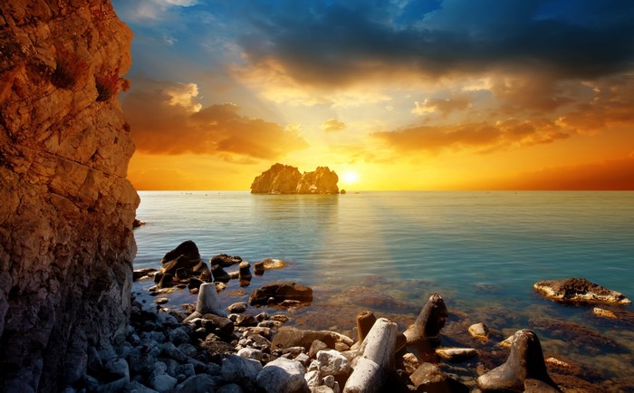 Rocky Shoreline at Sunset with Island