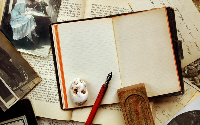 Vintage Notebook with Pen and Old Photographs