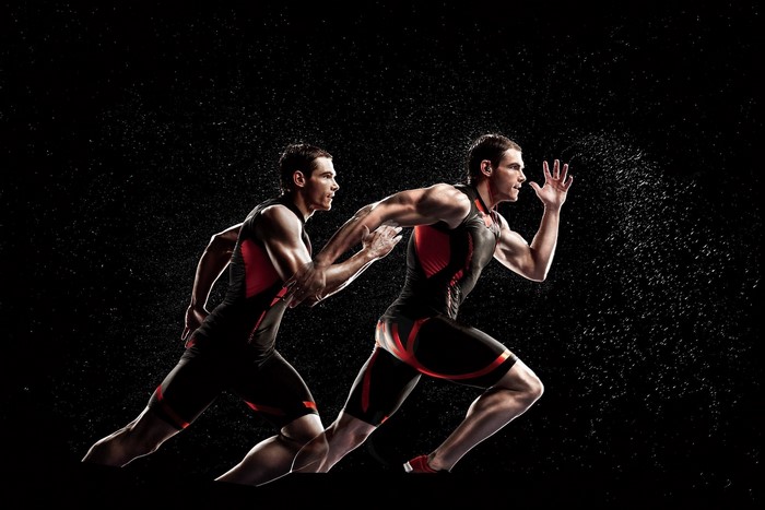 Athletes running with water spray
