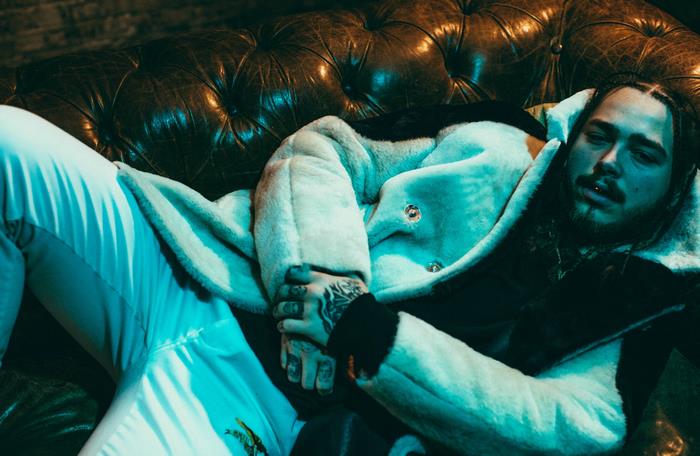 Post Malone on a leather couch