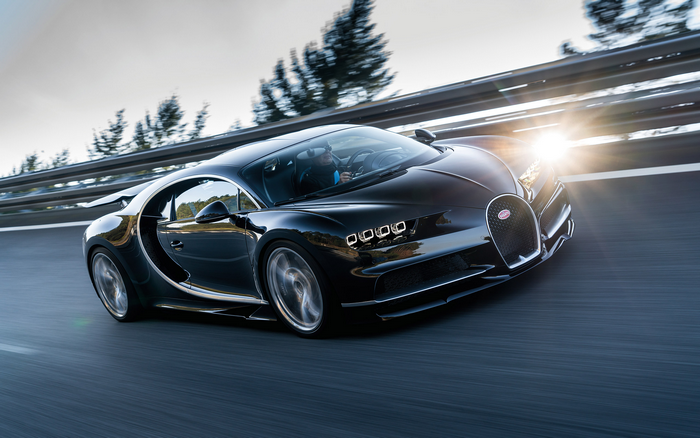 Black Bugatti Chiron driving on a road