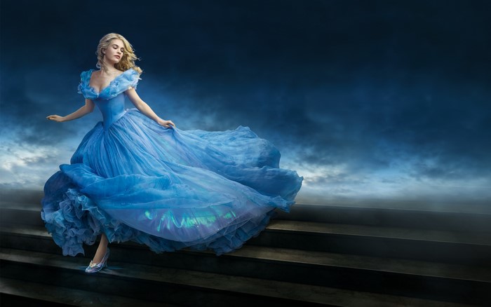 Lily James as Cinderella on stairs